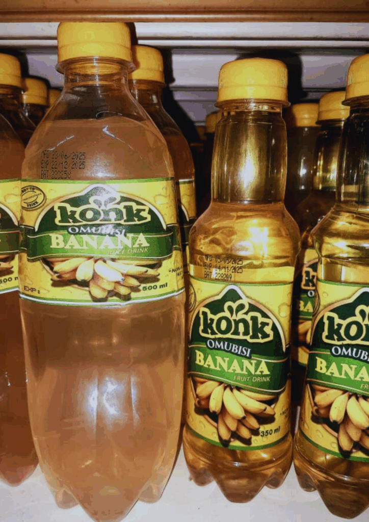 Konk Banana Juice bottles displayed on a supermarket shelf in a store, showcasing the product packaging. Ugandan innovation in a ready-to-drink format.