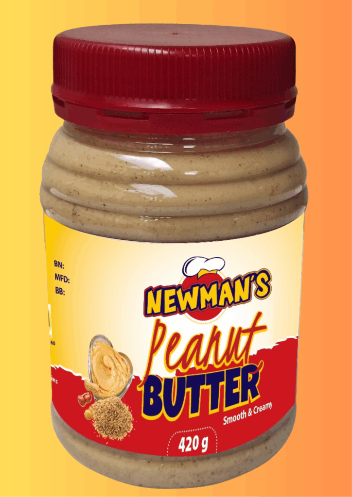 A jar of Newman's Peanut Butter, labeled "Smooth & Creamy," with a red screw-on cap. The label is yellow and red, featuring a bowl of peanut butter shaped like a heart, whole peanuts, and ground peanuts. The jar contains 420g of product.