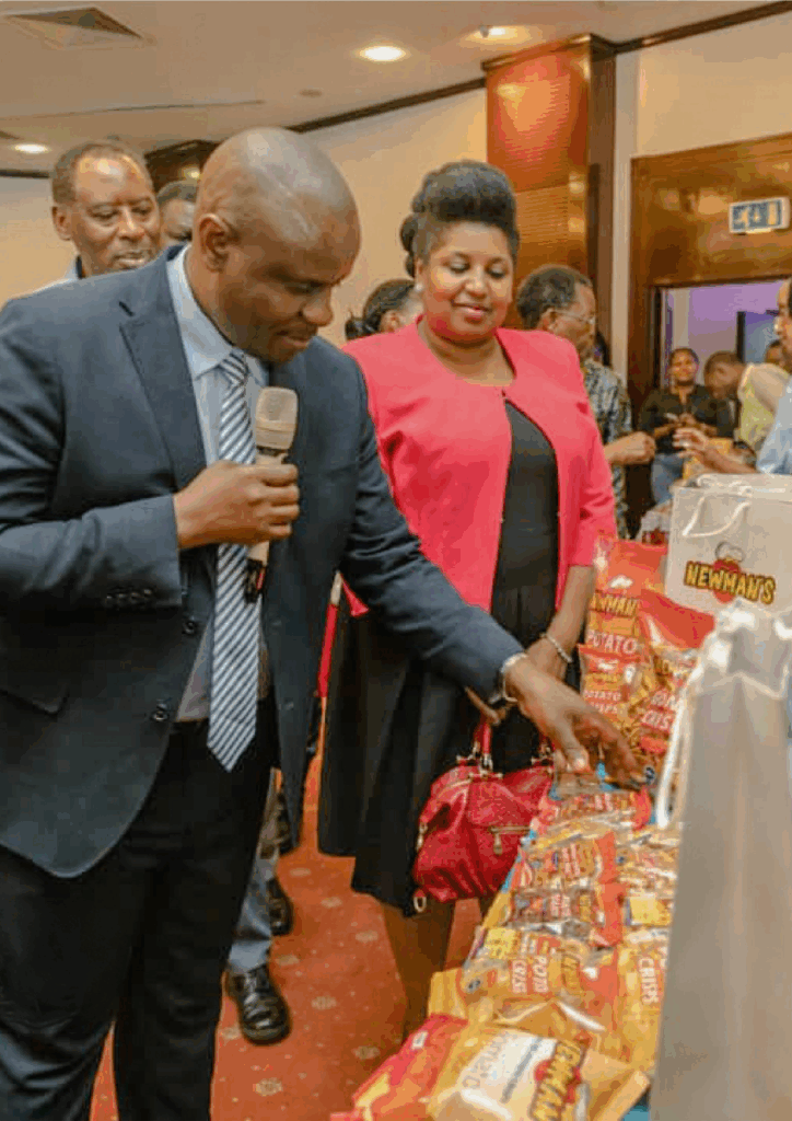 The Minister of State for Youth and Children Affairs, Hon. Dr. Balaam Barugahare Attenyi, viewing the Newman’s product exhibit at the 2024 Young Africa Works (YAW) exhibition at Serena Hotel