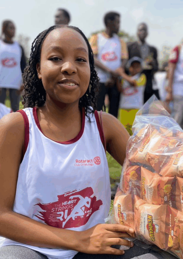 The photo of the Rotaract participant holding the large bag of snacks