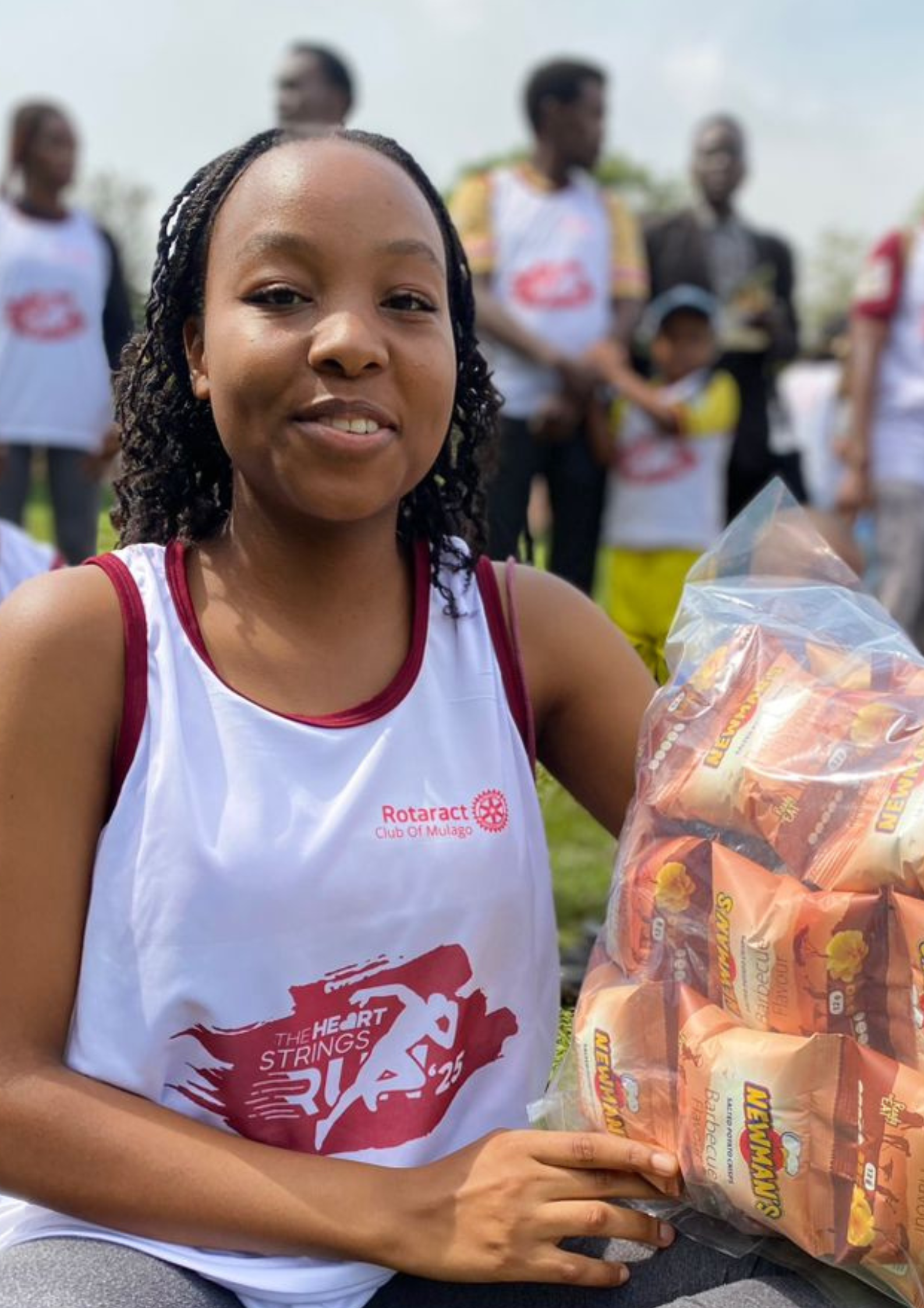 The photo of the Rotaract participant holding the large bag of snacks