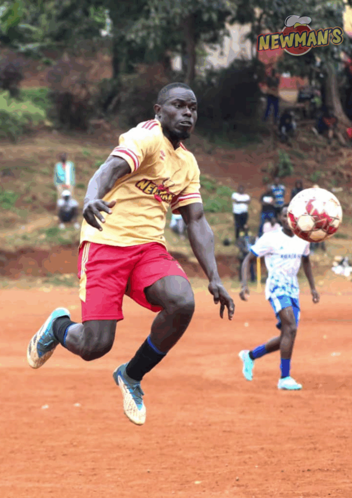 A football player in action wearing a jersey with the Newman's logo