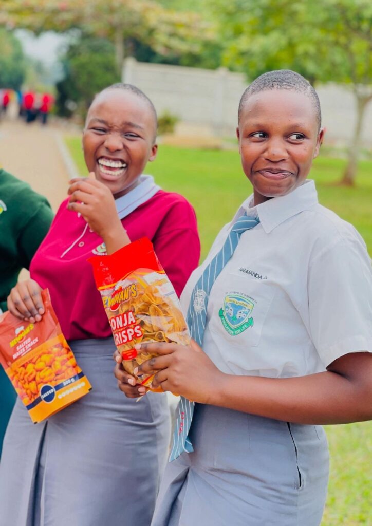 Students in school uniform enjoying Newman's snacks